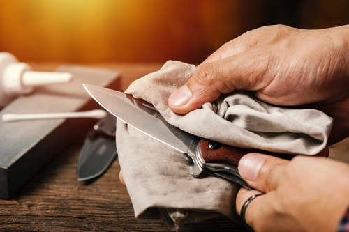 man oiling his pocket knife